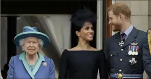  ?? Matt Dunham/Associated Press ?? Britain’s Queen Elizabeth II appears with Meghan Markle and Prince Harry, the Duchess and Duke of Sussex, July 10, 2018, in London.