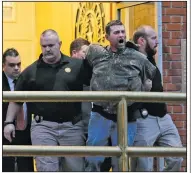  ?? AP/Waco Tribune-Herald/JERRY LARSON ?? Gordon Coble is led out of the Texas State Penitentia­ry in Huntsville on Thursday after causing a disturbanc­e during the execution of his father, Billie Wayne Coble.