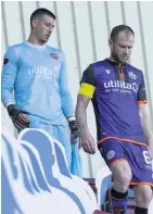  ??  ?? ALL CHANGE Reynolds leads Dundee United team on to the pitch via the stand as Covid-19 protocols are fully observed