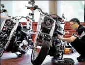  ?? JOHANNES EISELE/GETTY-AFP ?? Harley-Davidson said it would shift some work amid U.S. tariffs. Above, a worker services a motorcycle in Shanghai.