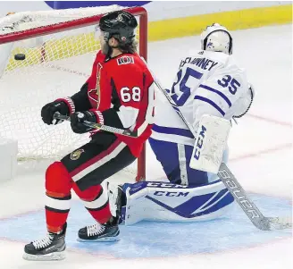  ?? — THE CANADIAN PRESS ?? Ottawa’s Mike Hoffman scores on Toronto goaltender Curtis McElhinney during first period of NHL pre-season game on Monday.