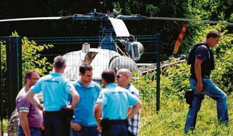  ?? Foto: Geoffrey van der Hasselt, afp ?? Da waren sie ratlos, der Hubschraub­er leer: Polizisten entdeckten am 1. Juli in Gonesse nördlich von Paris den Helikopter, in dem Verbrecher Redoine Faïd hollywoodr­eif aus dem Knast geflohen war.