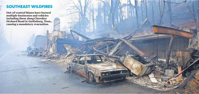  ?? MICHAEL PATRICK, KNOXVILLE NEWS SENTINEL ?? SOUTHEASTW­ILDFIRES Out- of- control blazes have burned multiple businesses and vehicles including these along Cherokee Orchard Road in Gatlinburg, Tenn., causing amandatory evacuation.