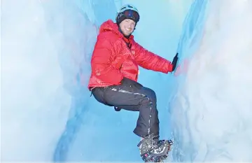  ??  ?? Abbamonte, who has visited more than 100 countries alone, explores the ice caves beneath the surface of Queen Maud Land in Antarctica.