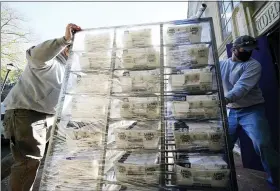  ?? MATT SLOCUM — THE ASSOCIATED PRESS ?? Chester County workers transport mail-in and absentee ballots to be processed at West Chester University on Wednesday.