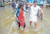 ?? PTI PHOTO ?? Residents wade through a waterlogge­d street following heavy rainfall in Kochi on Monday.