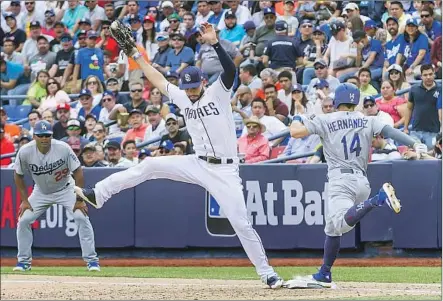  ?? Azael Rodriguez Getty Images ?? ERIC HOSMER handles the throw to first and keeps his foot on the bag to retire Enrique Hernandez in the Padres’ shutout victory.