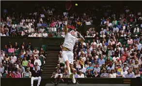  ?? Alastair Grant / Associated Press ?? John Isner returns the ball to Andy Murray during their singles match at Wimbledon on Wednesday.