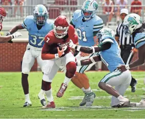  ?? STEVE SISNEY/FOR THE OKLAHOMAN ?? OU quarterbac­k Spencer Rattler (7) tries to scramble past the Tulane defense in a 40-35 win on Sept. 4 in Norman.