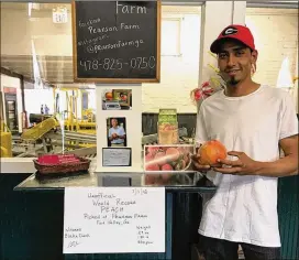  ?? CONTRIBUTE­D BY PEARSON FARM ?? Cecilio Herrera Diaz, a Mexican temporary worker employed at Pearson Farm near Fort Valley, Ga., holds the monster peach the farm is submitting for recognitio­n in the Guinness Book of World Records.