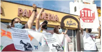  ?? PAT NABONG/SUN-TIMES ?? Janet Garcia (second from left) cheers with immigratio­n advocates Friday during a rally in Little Village to demand a pathway to citizenshi­p and an end to deportatio­ns.