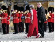  ?? DOUG MILLS / THE NEW YORK TIMES ?? British Prime Minister Theresa May escorts President Donald Trump into a gala dinner at Blenheim Palace near Oxford on Thursday. Trump is on a seven-day, threenatio­n European trip.