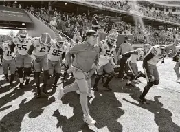  ?? Michael Woods / Associated Press ?? Coach Kirby Smart and No. 4 Georgia will be hosting No. 7 Auburn today in a game typically played in November. The rivalry dates back to 1892.