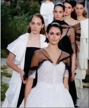  ?? ASSOCIATED PRESS ?? MODEL KAIA GERBER leads other models as they wear creations for the Chanel Haute Couture Spring/Summer 2020 fashion collection presented Tuesday Jan. 21 in Paris.
GUESTS