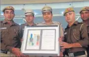  ??  ?? Police display the recovered Nobel citation.