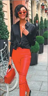  ?? CHRISTIAN VIERIG / GETTY IMAGES AND GOLDSTAR MEDIA / BACKGRID ?? From left: Alexandra Lapp wears orange long silk blouse from Alexander McQueen; Jourdan Dunn wears black shirt contrastin­g boldly with her bright red trousers.