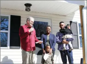  ?? The Sentinel-Record/Rebekah Hedges ?? WELCOME HOME: Jack Porter, Garland County Habitat for Humanity’s Board President, welcomes the Yamga family to their new home on Cones Road during a dedication ceremony March 3. The Yamga family, as well as the Gonzalez family and the Spencer family,...