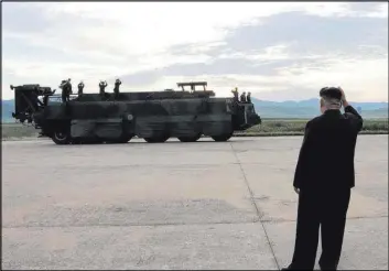  ?? The Associated Press ?? Kim Jong Un gestures at soldiers at Thursday’s test launch of an intermedia­te-range missile that flew over Japan. The U.S. and its allies responded to the launch by raising the prospect of cutting off North Korea’s oil supply.