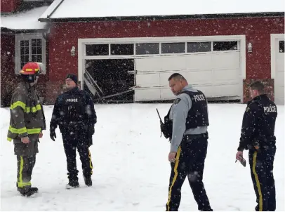  ?? CITIZEN PHOTO BY BRENT BRAATEN ?? RCMP and Prince George Fire Rescue members were on the scene at a Sadler Drive home on Monday afternoon. A stolen car was driven through the garage of the home.