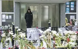  ?? Darko Vojinovic Associated Press ?? AN OFFICER guards the Vladislav Ribnikar school in Belgrade, the site of a mass shooting. Authoritie­s have told citizens to hand in illegal weapons or face prison.