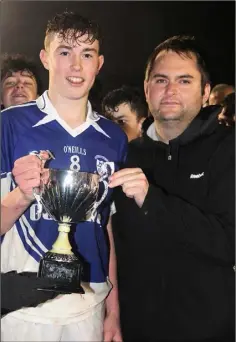  ??  ?? Ballyhogue captain John Kehoe with Dean Goodison of People Newspapers (sponsors) after receiving the trophy.