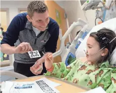  ?? GETTY IMAGES ?? New England Patriots magician John Duke Logan, who has entertaine­d the team during Super Bowl week, performed card tricks for Ayla at Boston Children's Hospital earlier this year.
