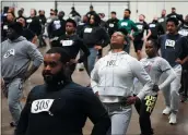  ?? MATT ROURKE — THE ASSOCIATED PRESS ?? Philadelph­ia police academy applicants warm up before the physical fitness entry exam in Philadelph­ia lat month.