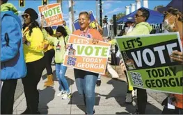  ?? Ben Gray Associated Press ?? U.S. CENSUS BUREAU data show that Democrats received less support from Black, Latino and Asian voters in last year’s midterm, which had a high turnout.