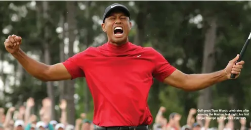  ?? Golf great Tiger Woods celebrates after winning the Masters last night, his first major triumph in 11 years. | REUTERS ??