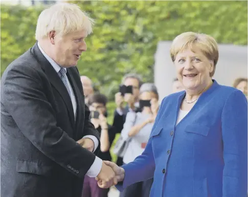  ??  ?? 0 Boris Johnson greets German Chancellor Angela Merkel in Berlin during his first foreign visit since becoming Prime Minister