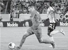  ?? Jim Watson / AFP / Getty Images ?? Christian Pulisic, left, scored two goals in the United States’ semifinal win over Jamaica. The U.S. will play Mexico in the final.