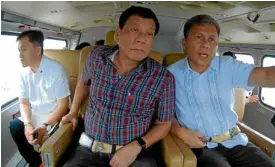  ?? MALACAÑANG PHOTO ?? PRESIDENT Duterte makes an aerial inspection of the flood-hit areas of the National Capital Region and Central Luzon yesterday with NDRRMC Executive Director Ricardo Jalad (right) and Special Assistant to the President Christophe­r Go.