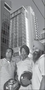  ?? IAN LINDSAY/VANCOUVER SUN ?? Crystal Consulting Inc. drywall contractor­s (from left) Gurpreet Sangha, Ajit Singh Sangha and Kuldeep Singh Chohan outside the Coast Hotel project on Pender Street in Vancouver.