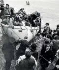  ??  ?? Survivors, some of them children, are brought to shore in lifeboats during the dramatic Wahine rescue depicted in these pictures, left and above.