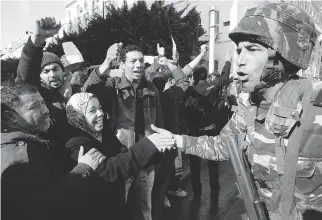  ?? CHRISTOPHE ENA/THE ASSOCIATED PRESS FILES ?? Tunisian protesters greet soldiers during a 2011 demonstrat­ion. A Tunisian democracy group won the Nobel Peace Prize for its role in the country’s Arab Spring movement.