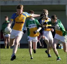  ??  ?? James Kelly of Taghmon-Camross about to kick under pressure from Duffry Rovers defender Callum Boyce.