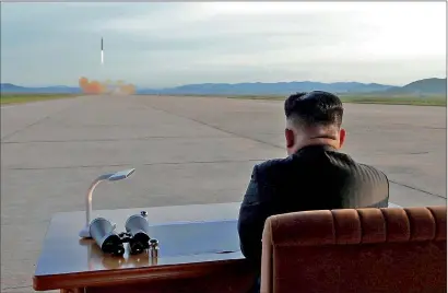  ?? Reuters ?? North Korean leader Kim Jong-un watches the launch of the medium-and-long range strategic ballistic rocket Hwasong-12 missile in this undated photo released by North Korea’s Korean Central News Agency on Saturday.—