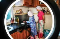  ??  ?? Moe Myint May Thu (left) and her mother Honey Cho filming a cooking video at their house in Yangon.