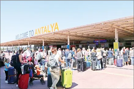  ??  ?? British passengers with Thomas Cook wait in long queue at Antalya airport in Antalya, Turkey, on Sept 23. Hundreds of thousands of travellers were stranded across the world Monday after British tour company Thomas Cook collapsed, immediatel­y halting almost all its flights and hotel services and
laying off all its employees. According to reports Monday morning some 21,000 Thomas Cook travellers were stranded in Turkey alone. (AP)
