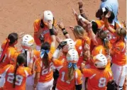  ?? THE ASSOCIATED PRESS FILE PHOTO ?? Tennessee’s Megan Geer, top center, is greeted by teammates after hitting a home run against Florida during the 2015 Women’s College World Series. Now a senior, the outfielder has played in 37 games this season and is hitting .347 with five doubles,...