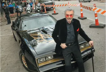  ?? AP FILE PHOTOS ?? ABOVE: Burt Reynolds sits on a 1977 Pontiac Trans-Am at the world premiere of The Bandit at the Paramount Theatre during the South by Southwest Film Festival in March 2016 in Austin, Texas. BELOW: In this photo from March 1987, Reynolds and Loni Anderson appear at a polo match in Boca Raton, Fla.