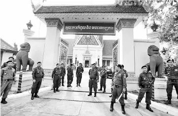  ??  ?? Police officers stand guard at the Supreme Court during a hearing to decide whether to dissolve the main opposition Cambodia National Rescue Party (CNRP), in Phnom Penh, Cambodia. — Reuters photo