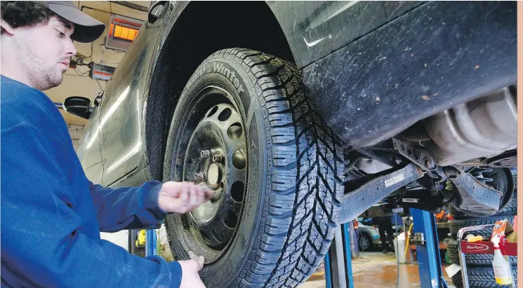  ?? CLIFFORD SKARSTEDT/PETERBOROU­GH EXAMINER FILES ?? Nate Davis installs a winter tire at Curry Tire in Peterborou­gh, Ont. All-season tires get brittle and ineffectiv­e below 7C, research shows.