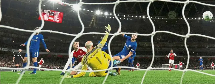  ?? — Reuters ?? Watch this one go in: Arsenal’s Granit Xhaka (second from left) scoring the second goal in the League Cup semi-final second-leg match against Chelsea at the Emirates on Wednesday.