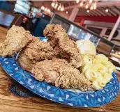  ??  ?? Fried chicken options include mashed potatoes, macaroni and cheese and a biscuit at Earl Abel’s.