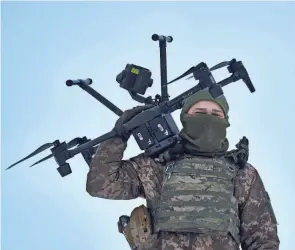  ?? LIBKOS/AP ?? A Ukrainian soldier carries a drone close to the front line Friday near Avdiivka in the Donetsk region of Ukraine.