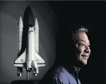  ?? Gary Coronado Los Angeles Times ?? FORMER ASTRONAUT Leroy Chiao, shown at his Houston home, was on a panel that assessed a George W. Bush-era plan to return to the moon as soon as 2015. “It was not funded to the level it needed to be,” he said.