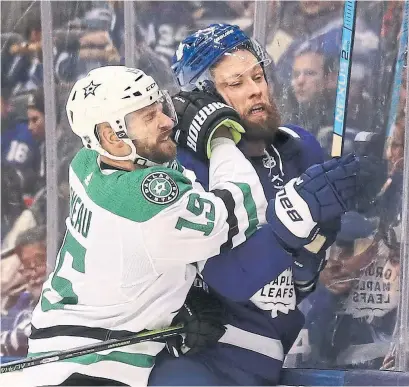  ?? RICHARD LAUTENS TORONTO STAR ?? Maple Leafs defenceman Jake Muzzin gets the worst of Stars winger Blake Comeau’s hit behind the Leafs net on Thursday.