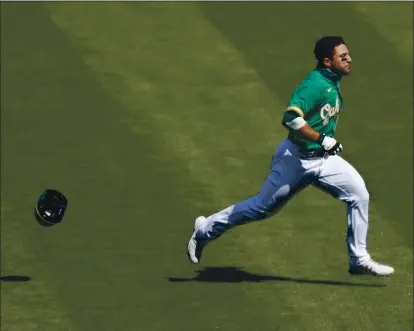  ?? NHAT V. MEYER — STAFF PHOTOGRAPH­ER ?? The A’s Ramon Laureano charges toward Houston hitting coach Alex Cintrón in the seventh inning of Sunday’s game at the Coliseum.