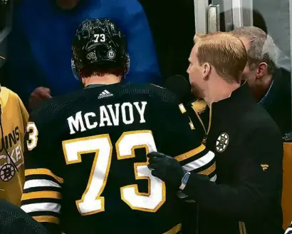  ?? JOHN TLUMACKI/GLOBE STAFF ?? Bruins defenseman Charlie McAvoy was brought to his knees after a third-period collision with Buffalo’s JJ Peterka, which resulted in McAvoy leaving the game with an upper-body injury.